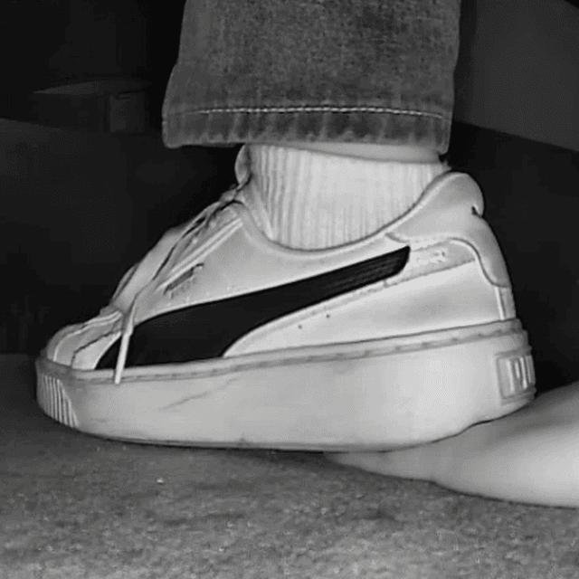 Woman candid hand trample with white socks and Puma sneakers in cinema 2