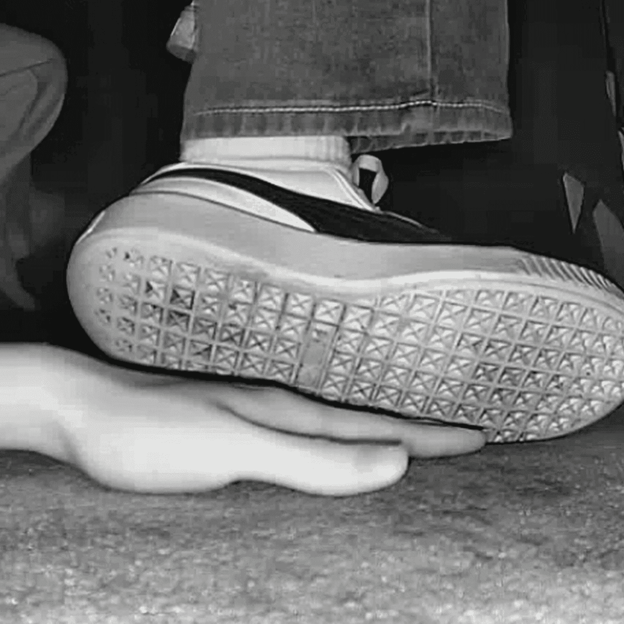 Woman candid hand trample with white socks and Puma sneakers in cinema thumb 3