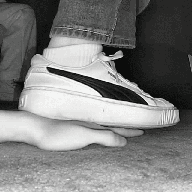 Woman candid hand trample with white socks and Puma sneakers in cinema 1