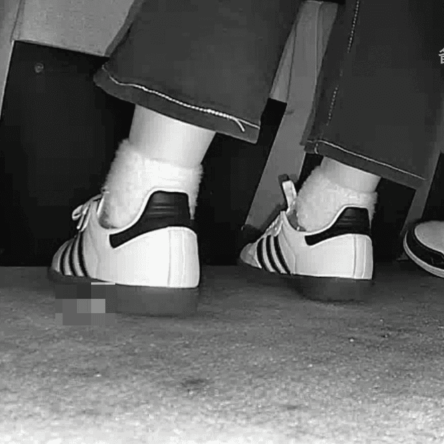 Woman candid crushing with Adidas Samba shoes in cinema 3