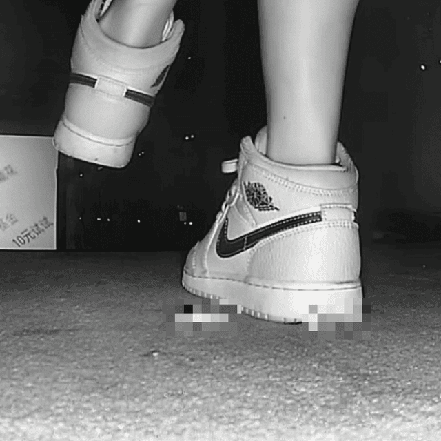 Woman candid crush with Air Force 1 sneakers in cinema 1