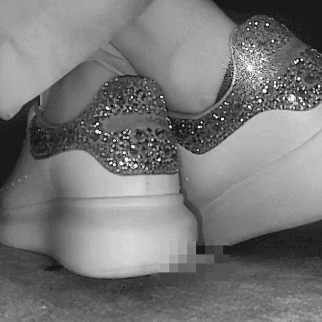 Woman in Alexander McQueen sneakers candid crushing in cinema 3