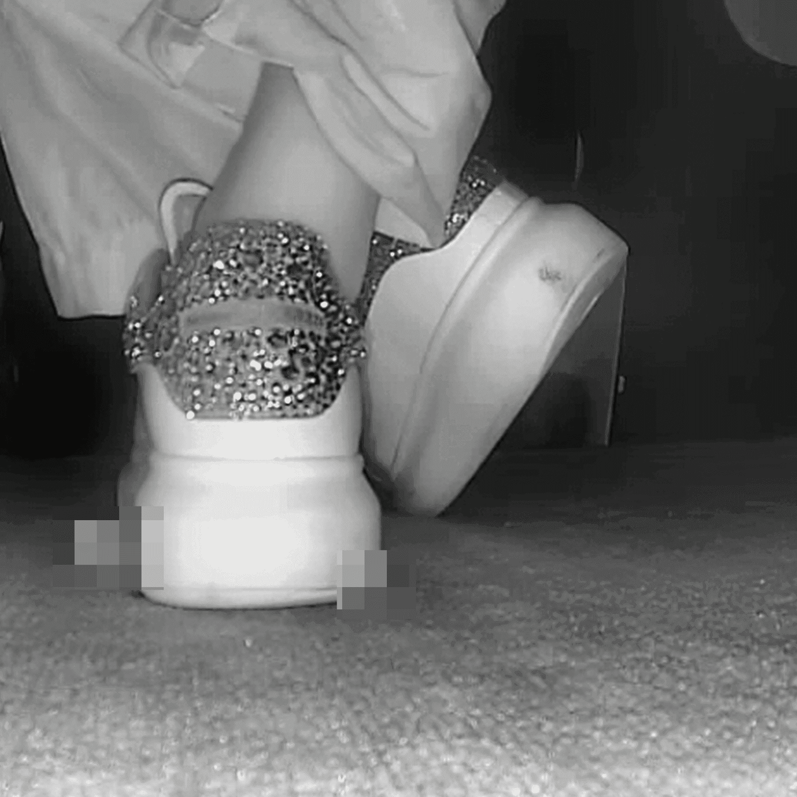 Woman in Alexander McQueen sneakers candid crushing in cinema