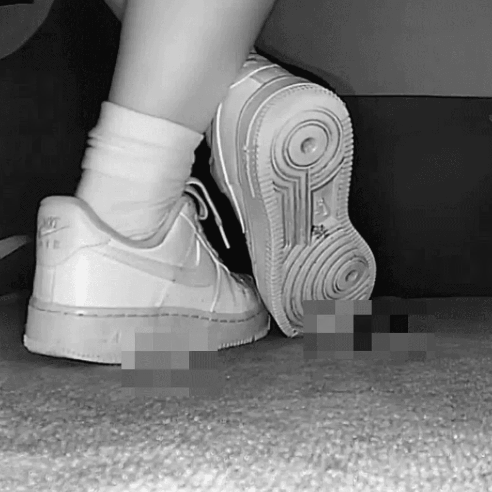 Woman candid crushing with white socks and Nike Air Force 1 in cinema
