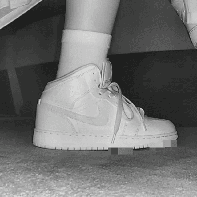 Woman at the cinema with white high-top Nike Air Jordan sneakers candid crushing 1